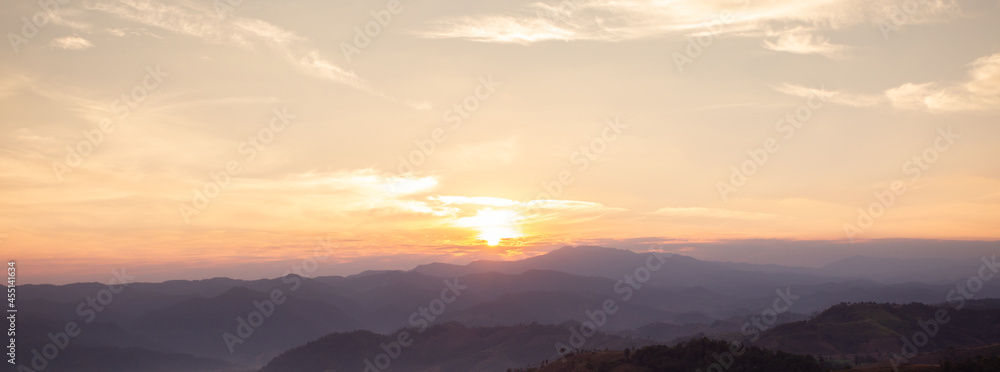 Landscape view of mountain at sunrise. Environmental background. Cloudy sky for web banner.