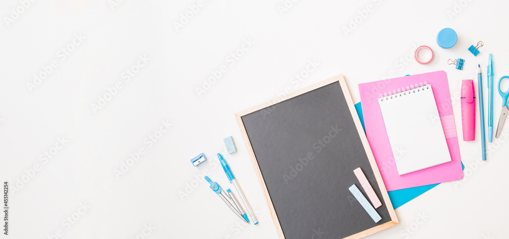 Black chalkboard mockup with flat lay school and office supplies on a white background Black chalkboard mockup with flat lay school and office supplies on a white background