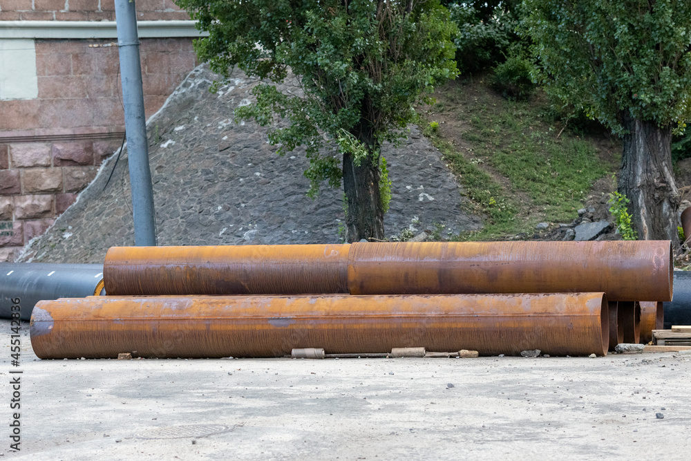 Big rusty water pipes on construction site Big rusty water pipes on construction site