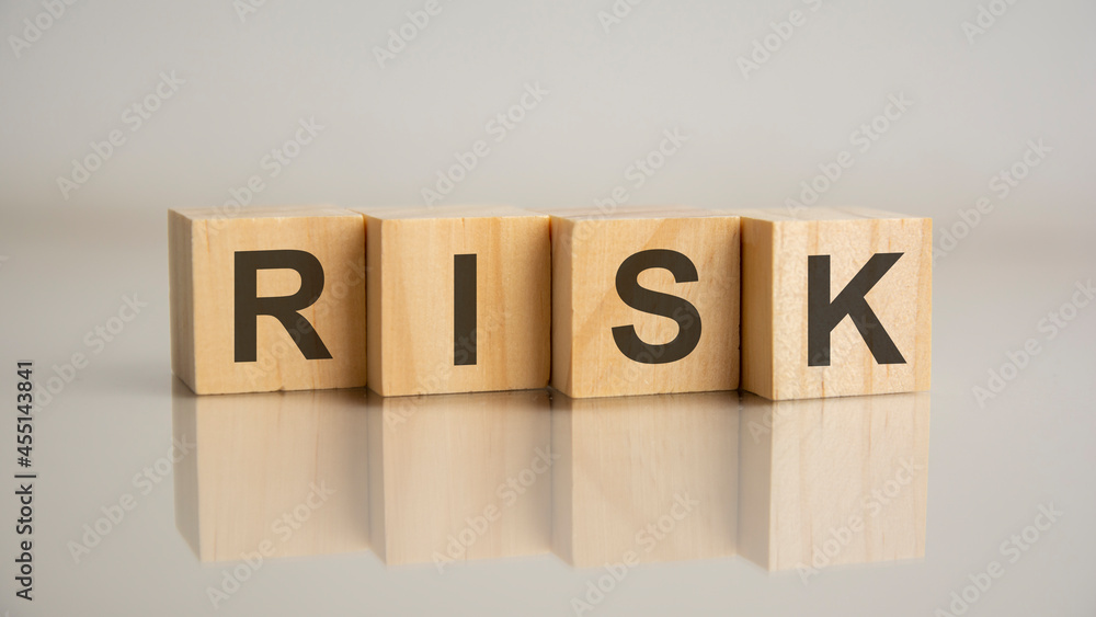 Four wooden cubes with letters risk. Business marketing concept. Four wooden cubes with letters risk. Business marketing concept.