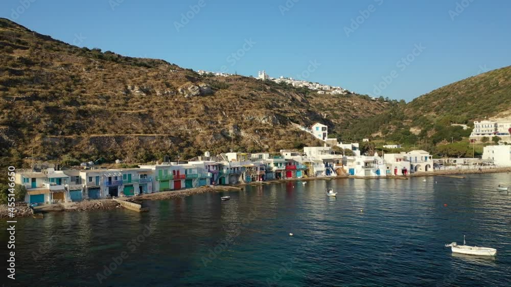 Aerial drone video from picturesque seaside village of Klima and traditional fishermen settlement with colourful boat garages called syrmata in island of Milos, Cyclades, Greece Aerial drone video from picturesque seaside village of Klima and traditional fishermen settlement with colourful boat garages called syrmata in island of Milos, Cyclades, Greece