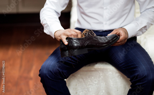 Man holding elegant black shoes