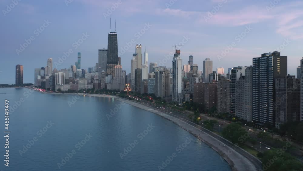 Downtown Chicago night scene. Chicago city streets light at dusk with pink sunset on motion background. Chicago aerial shot and modern waterfront skyscraper buildings. 4K drone footage, USA Illinois Downtown Chicago night scene. Chicago city streets light at dusk with pink sunset on motion background. Chicago aerial shot and modern waterfront skyscraper buildings. 4K drone footage, USA Illinois