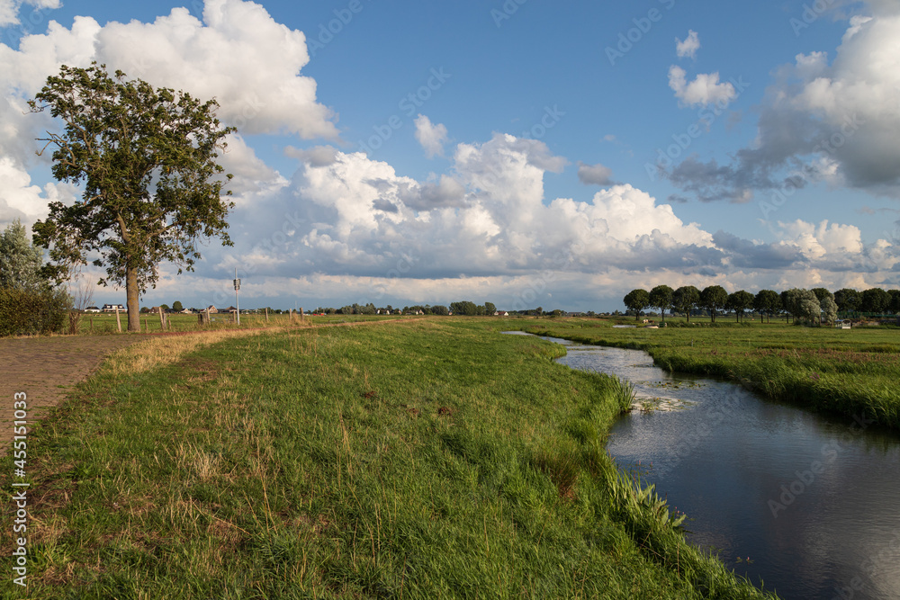 Fototapeta premium Small river in the rural polder landscape near the village of Eemnes in the Netherlands.