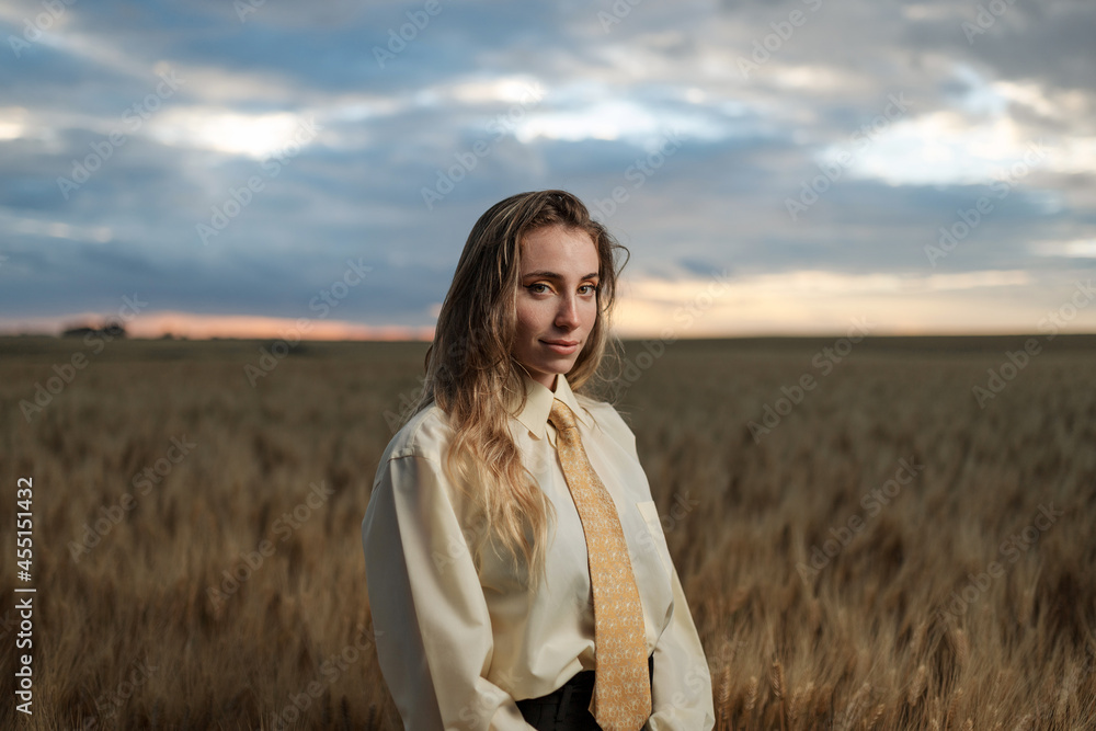 Stylish thoughtful model in wheat field under cloudy sky Stylish thoughtful model in wheat field under cloudy sky