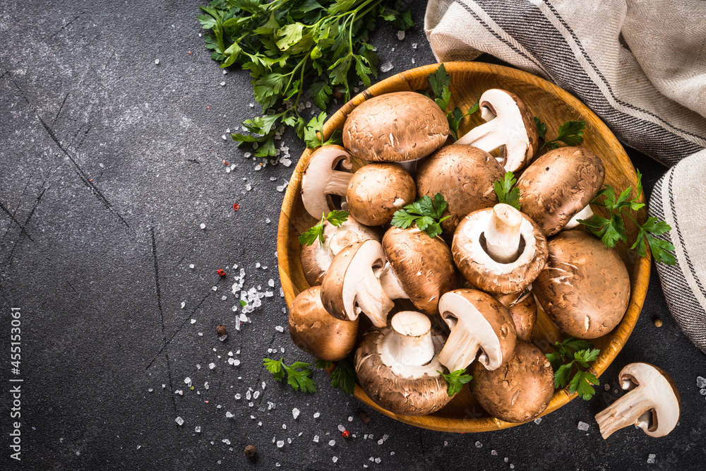 Champignon. Fresh organnic mushrooms in wooden bowl ready for cooking. Top view with copy space. Champignon. Fresh organnic mushrooms in wooden bowl ready for cooking. Top view with copy space.