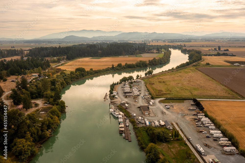 Aerial View of the Skagit River, Mt. Vernon, Washington. Drone shot of the Skagit River running through agricultural fields with the Cascade Mountains in the background.