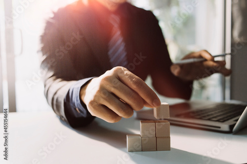 Hand arranging wood cube stacking. Business concept growth success,hand stack woods block step on table. business development concept.copy space.