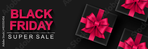 Black Friday super sale banner. Black gift box with pink bows dark background. Big seasonal sale discount prices horizontal poster. Vector illustration with realistic elements for header website