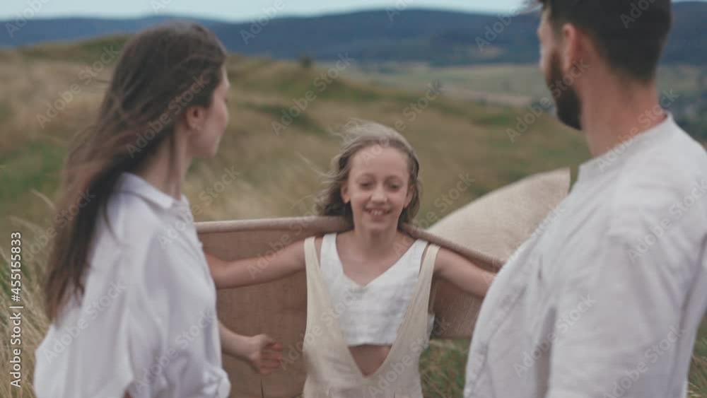 Happy daughter embracing parents on nature Happy daughter embracing parents on nature