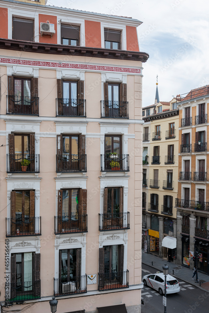 Facade of vintage building with large viewpoints to the street in the center of Madrid