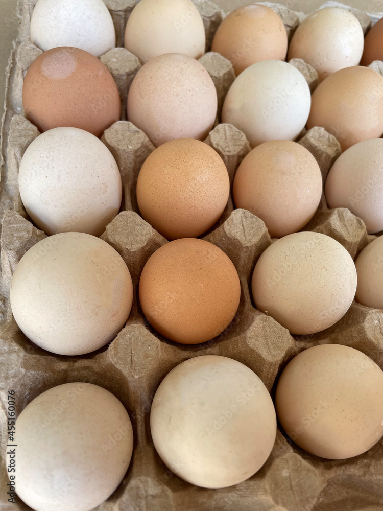 Overhead view of free-range organic chicken brown eggs in tray. Background with chicken eggs. Eggs for Easter. Background for cafes, restaurants, fast food outlet. Craft background. Overhead view of free-range organic chicken brown eggs in tray. Background with chicken eggs. Eggs for Easter. Background for cafes, restaurants, fast food outlet. Craft background.