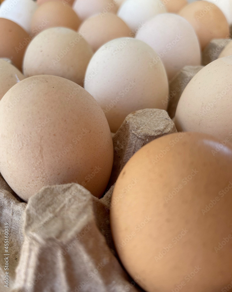 Overhead view of free-range organic chicken brown eggs in tray. Background with chicken eggs. Eggs for Easter. Background for cafes, restaurants, fast food outlet. Craft background. Overhead view of free-range organic chicken brown eggs in tray. Background with chicken eggs. Eggs for Easter. Background for cafes, restaurants, fast food outlet. Craft background.