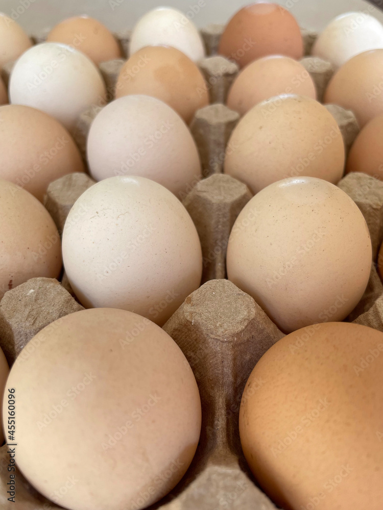 Overhead view of free-range organic chicken brown eggs in tray. Background with chicken eggs. Eggs for Easter. Background for cafes, restaurants, fast food outlet. Craft background. Overhead view of free-range organic chicken brown eggs in tray. Background with chicken eggs. Eggs for Easter. Background for cafes, restaurants, fast food outlet. Craft background.