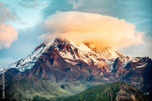 Scenic close up view of Kazbek mountain covered with sunny cloud in Stepantsminda Georgia photo