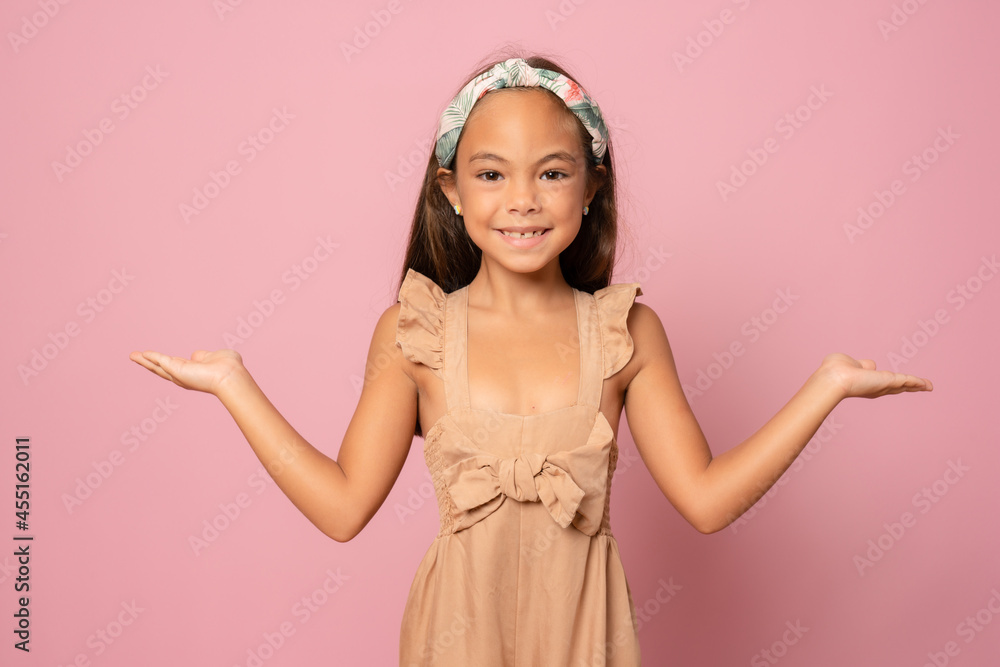 Kid happy smiling face show something on open palm copy space. Girl demonstrate product. Advertisement and commercial concept. Kid happy smiling face show something on open palm copy space. Girl demonstrate product. Advertisement and commercial concept.