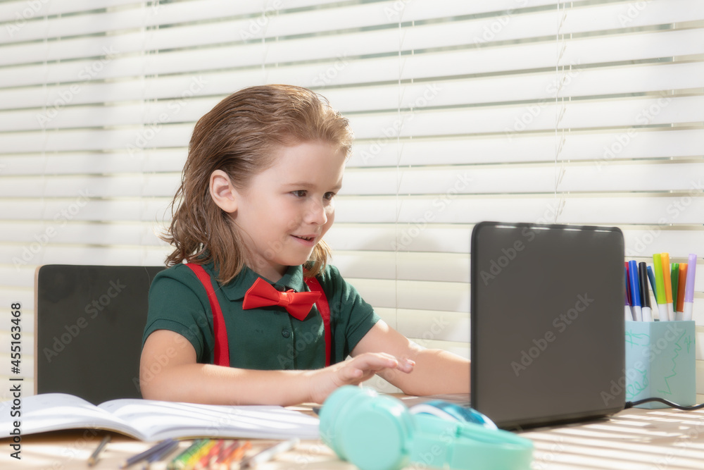 Back to school. Funny school boy from elementary school with book and laptop. Education. Kid with school supplies. Back to school. Funny school boy from elementary school with book and laptop. Education. Kid with school supplies.
