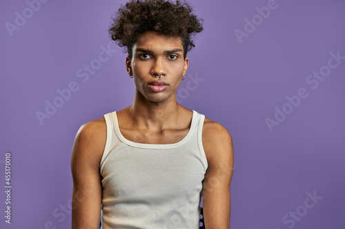 Close up portrait of young black man in white t-shirt with serious expression face