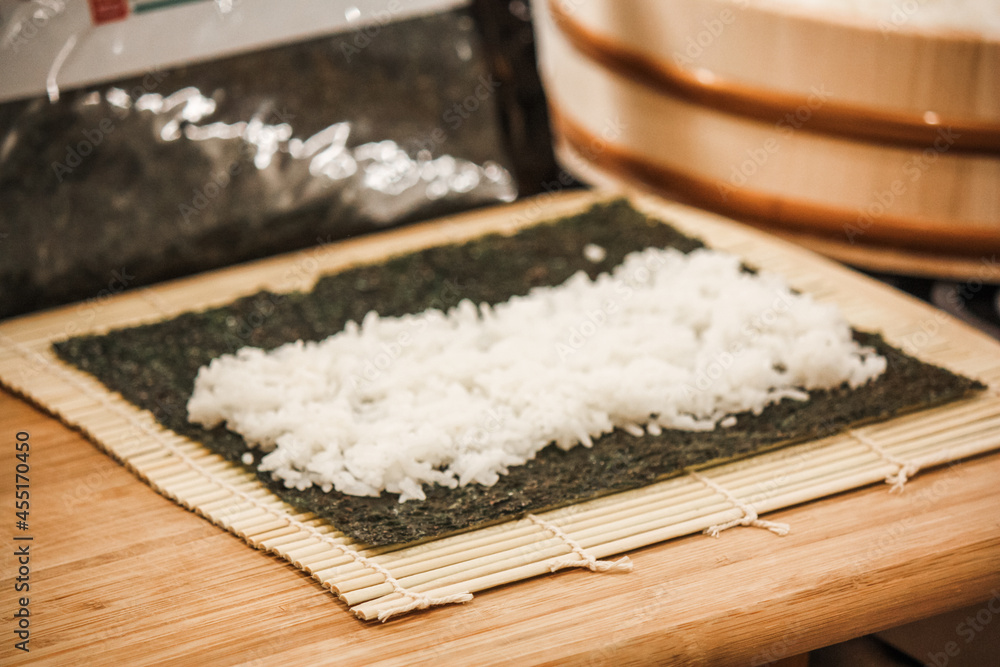 Homemade cucumber sushi roll preparation – in progress Homemade cucumber sushi roll preparation – in progress