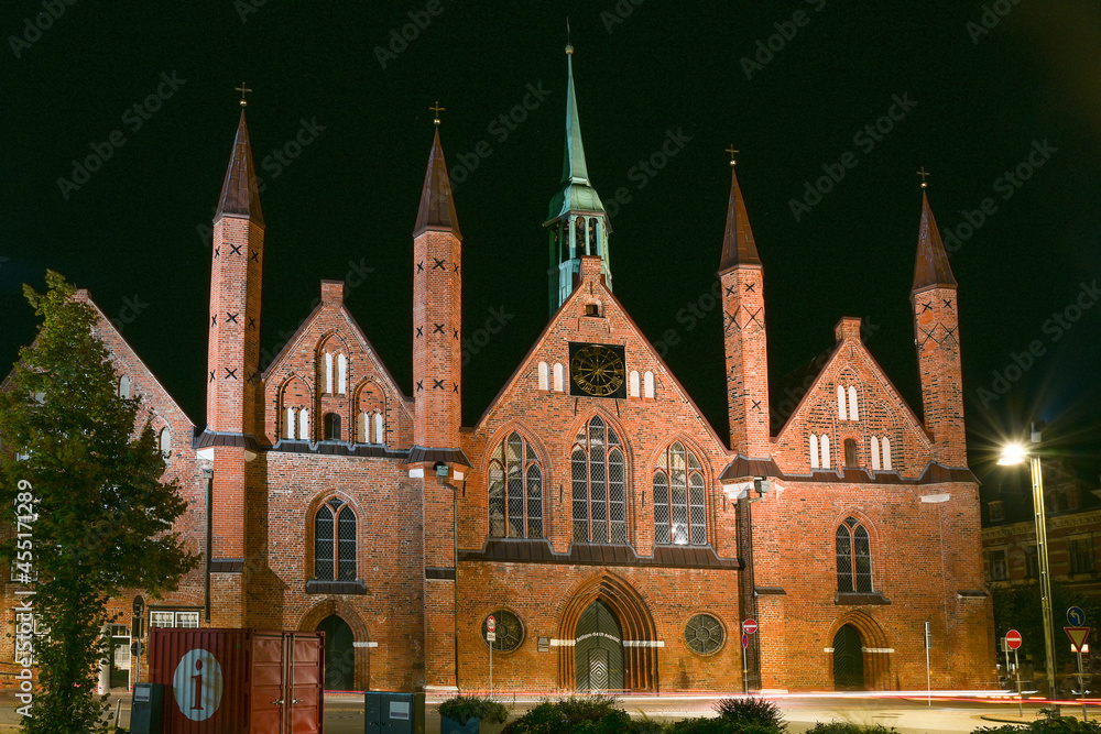 Heiligen Geist Hospital (Holy Spirit Hospital) in Lubeck at night, one of the oldest existing social institutions in the world and a significant historic brick building landmark in the city