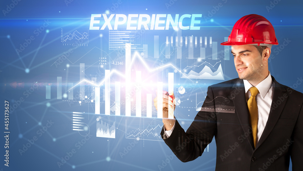 Young businessman with helmet drawing on virutal screen Young businessman with helmet drawing on virutal screen