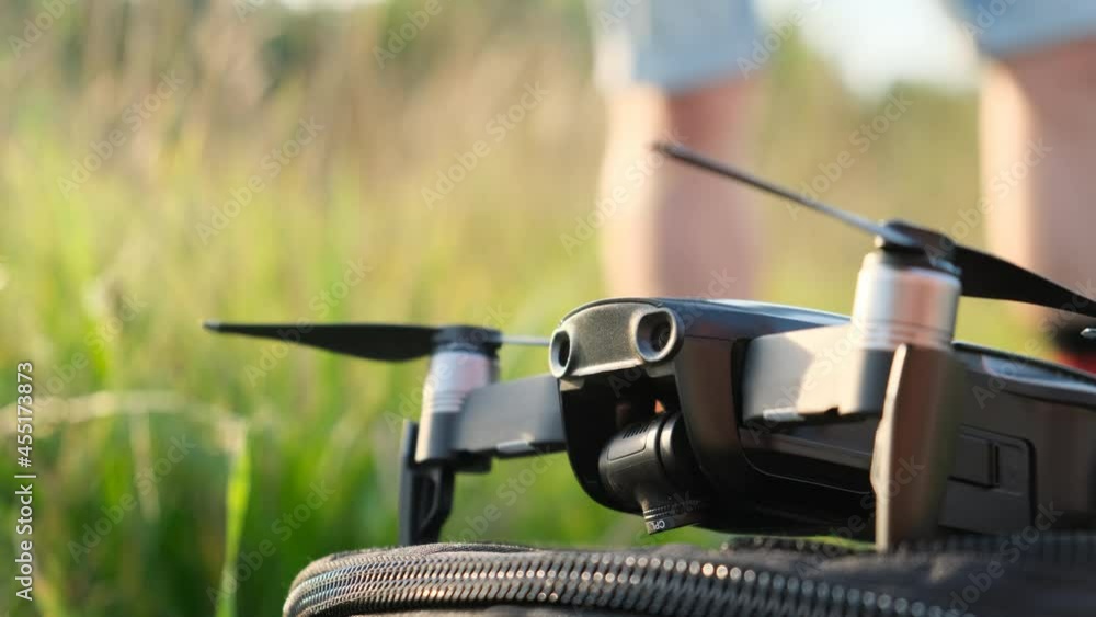 Close up of drone get ready to flight. Camera extreme close up footage calibration. Take off quadrocopter on nature in green field. Close up of drone get ready to flight. Camera extreme close up footage calibration. Take off quadrocopter on nature in green field.