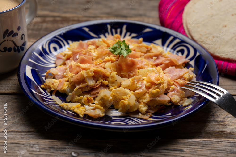 Scrambled eggs with ham for breakfast on wooden background Scrambled eggs with ham for breakfast on wooden background