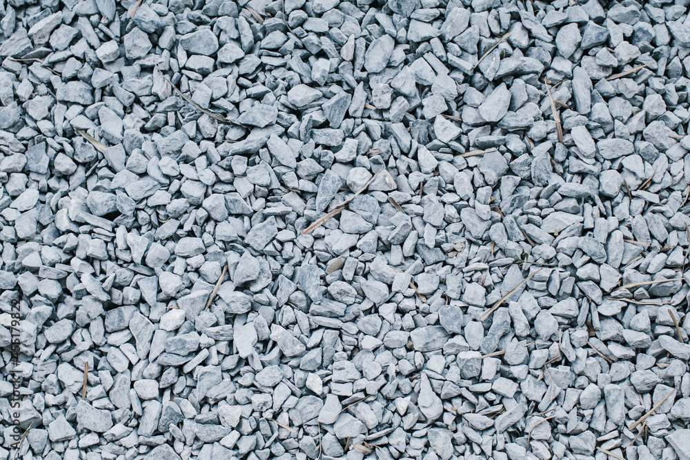 Gray crushed gravel stones on ground texture background. Small rocks used for construction of buildings Gray crushed gravel stones on ground texture background. Small rocks used for construction of buildings