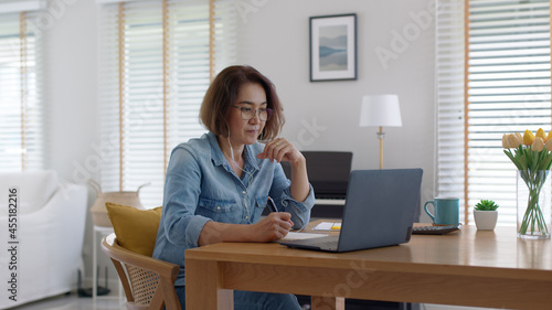 Asia adult happy people or sme owner latin lady sit consult talk in online seminar reskill upskill job discuss class for worker on desk table work at home in remote teach advice by digital training.