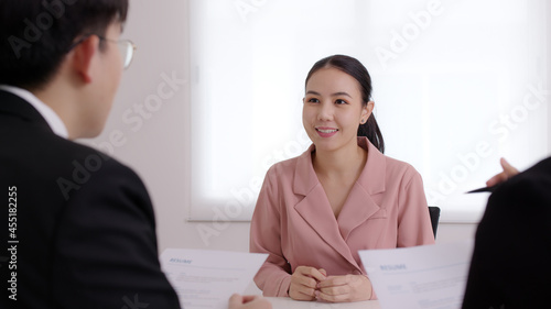 Fotografia Asia young people jobless female or happy trainee student sit talk in company meeting with HR at office desk for employee new hire, review internship portfolio, customer positive feedback discussion