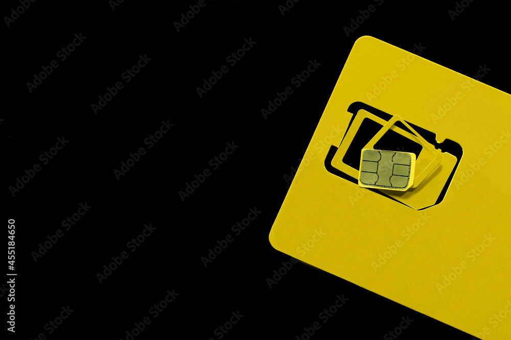 Multi SIM card on black background, top view. Space for text