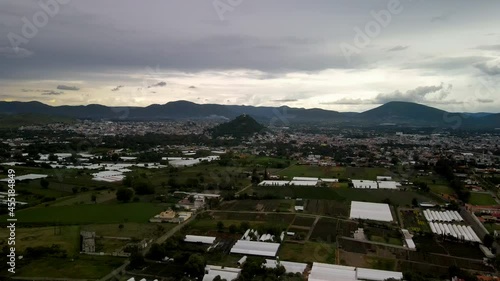 View of a storm above church in central mexico valley photo