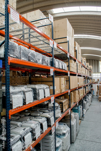 Concentration of industrial products in the COVID-19 era. Warehouse or warehousing and shelving with industrial equipment, warehouse central aisle view