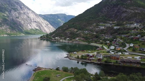 Eidfjord seafront view - Sideways moving aerial with eidfjord river and Simadalen valley in background photo