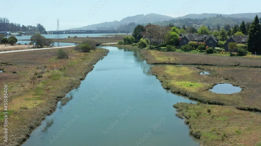 Drone shot of an estuary canal in a wetlands estuary with footbridge. Drone shot of an estuary canal in a wetlands estuary with footbridge.