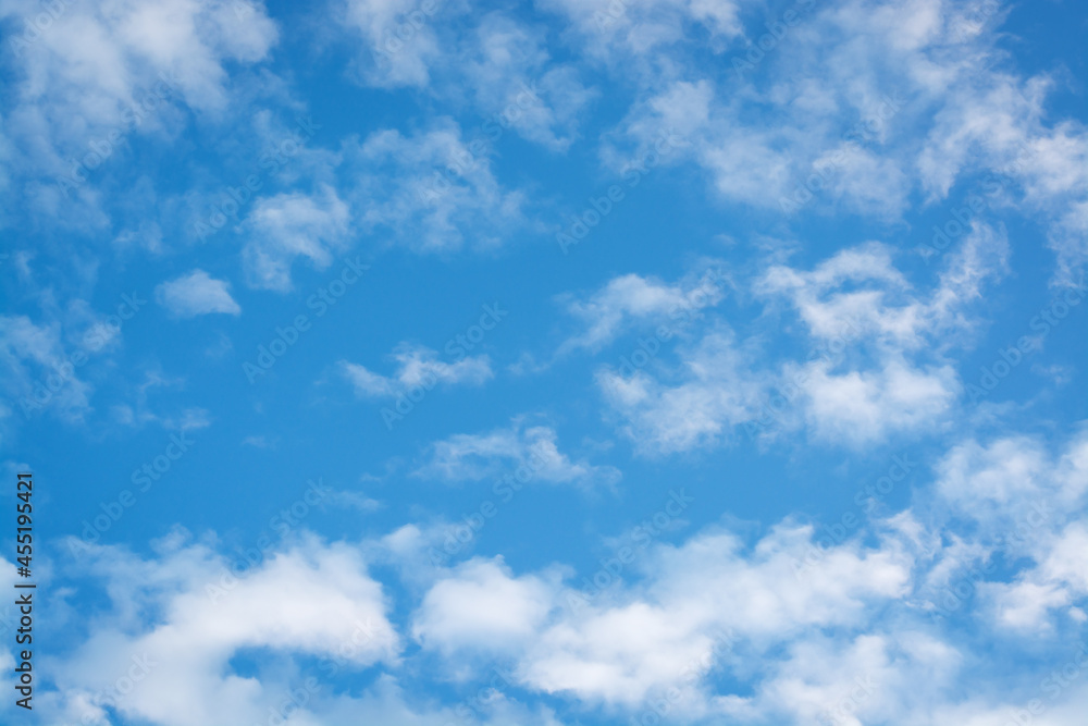 Background with white clouds from the corner edge and blue sky
