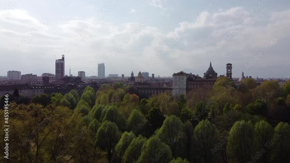 Cinematinc 60fps aerial shot revealing beautiful city behind trees Cinematinc 60fps aerial shot revealing beautiful city behind trees