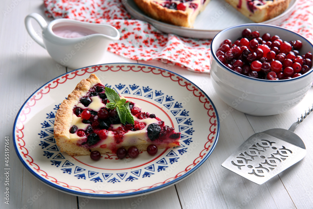 Piece of delicious currant pie served on white wooden table Piece of delicious currant pie served on white wooden table