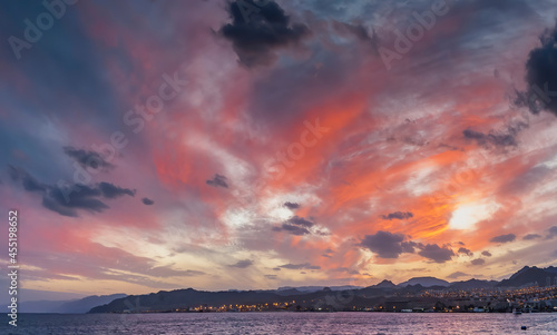 Colorful image with dramatic clouds during sunrise or at dawn
