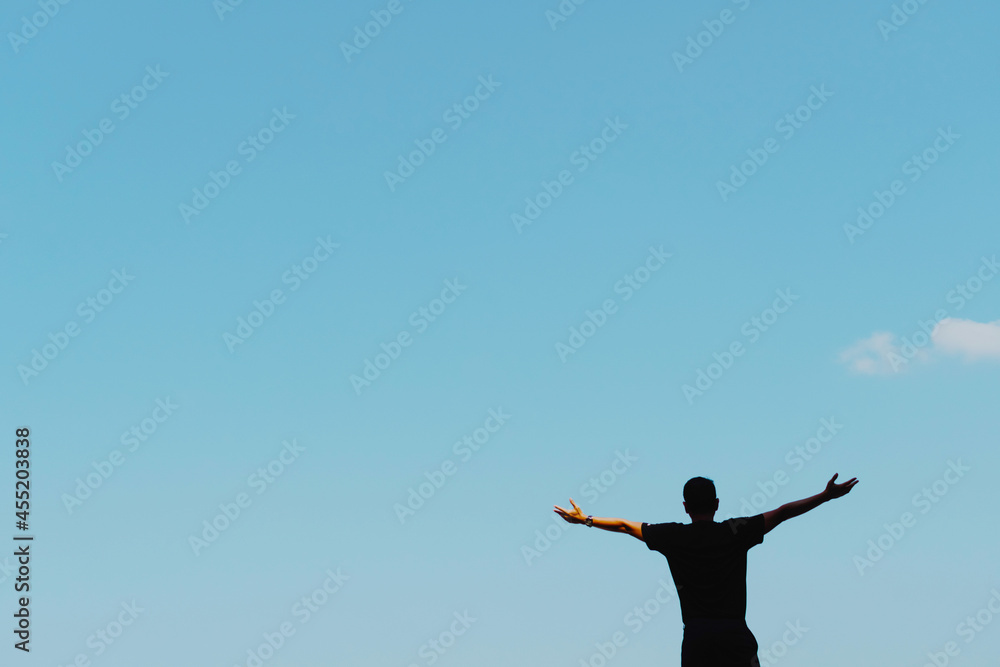 Copy space freedom man hand rising up summer vacation and freedom concept blue sky and mountain in abstract summer background. Copy space freedom man hand rising up summer vacation and freedom concept blue sky and mountain in abstract summer background.