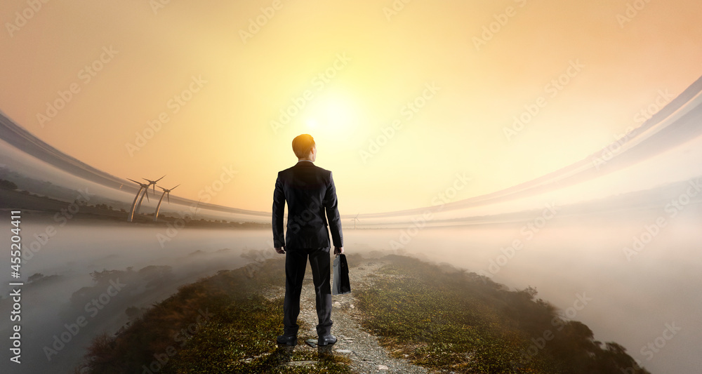 Businessman standing in front of landscape . Mixed media