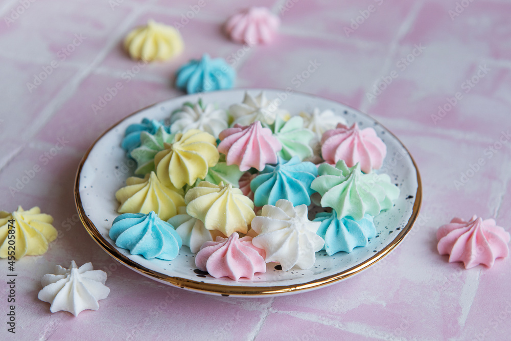 Small colorful meringues in the ceramic  plate