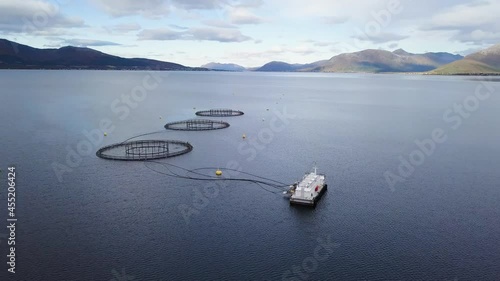 Aerial view of salmon farm in Norway surrounded my mountains in nature photo