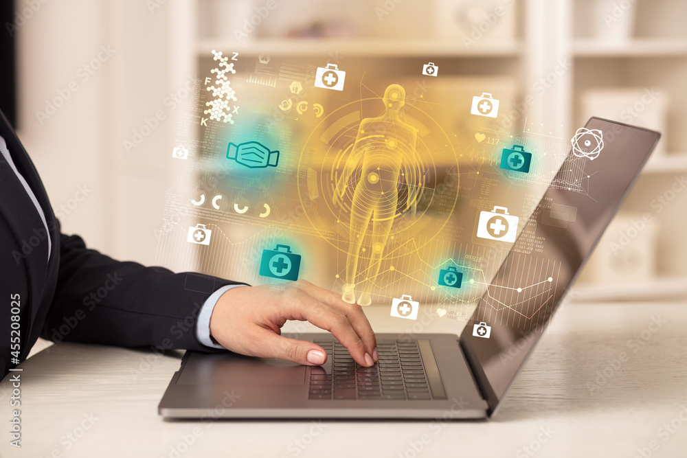 Doctor working on laptop with healthcare concept Doctor working on laptop with healthcare concept