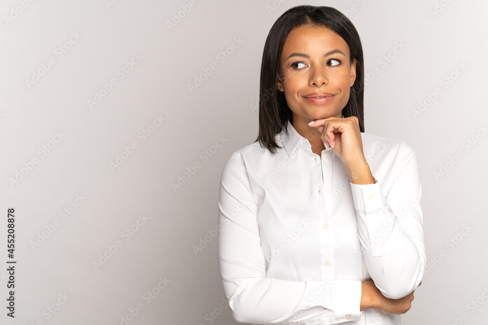 Thoughtful young african american woman touch chin, looking aside at copy space. Successful businesswoman in white shirt thinking of deal success smiling, client customer deciding about shopping offer Thoughtful young african american woman touch chin, looking aside at copy space. Successful businesswoman in white shirt thinking of deal success smiling, client customer deciding about shopping offer