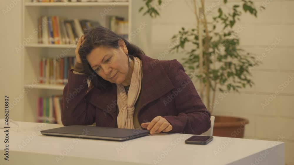 Exhausted desperate woman finishing work at laptop after long day at work,close up shot Exhausted desperate woman finishing work at laptop after long day at work,close up shot