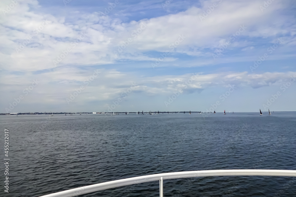 View from the boat to Baltic sea with many yachts. Light blue sky with many clouds. Regatta, race in frames of ORC 2021 Championship. Tallinn, Estonia. August 2021.