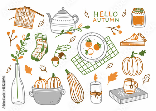 Set of autumn elements - warm socks, teapot with a cup, pumpkins, jam, pumpkin pie, candle, acorns and others. Hand-drawn vector doodle illustration. Perfect for cards, holiday designs, decorations.