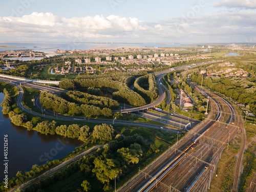 Aerial view of an infrastructure highway with cars going over it driving