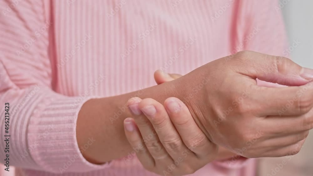 Closeup of female holding her painful wrist caused by prolonged work on the computer or housewife, Carpal tunnel syndrome, arthritis. Neurological disease concept. Closeup of female holding her painful wrist caused by prolonged work on the computer or housewife, Carpal tunnel syndrome, arthritis. Neurological disease concept.